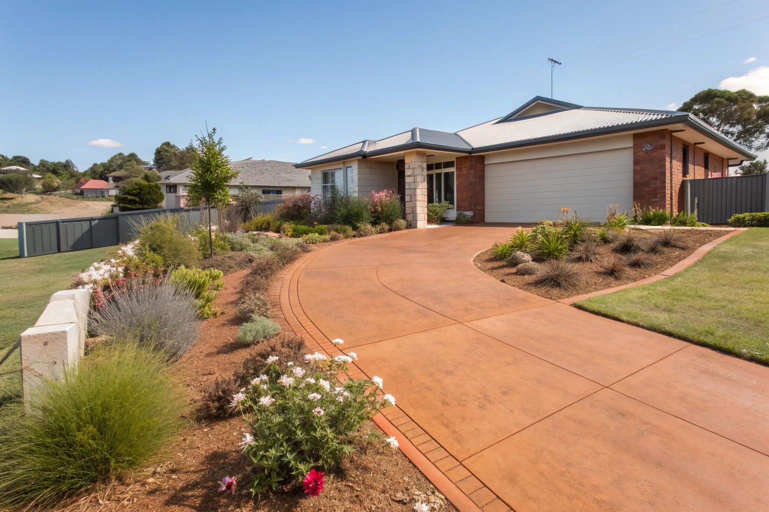 Terracotta coloured concrete driveway Canberra home