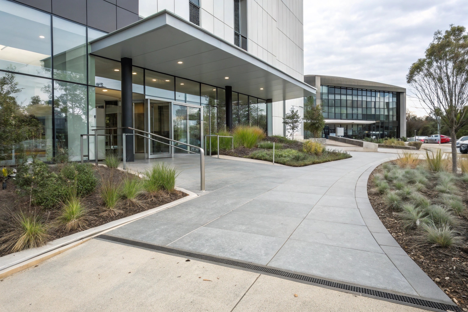 Commercial concrete entrance with accessible ramp at Barton ACT business property